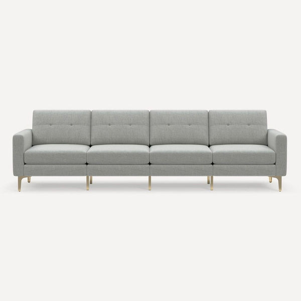 Modern light gray Burrow sofa with gold legs, seating four comfortably in any contemporary living room.