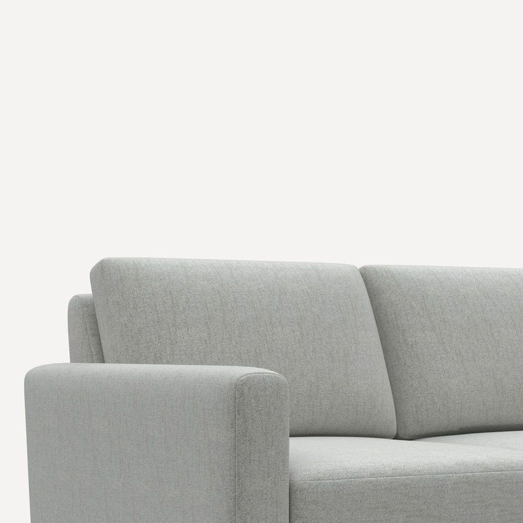 Burrow 4-seat sofa in soft gray fabric, featuring sleek lines, plush cushions, and durable brass accents.