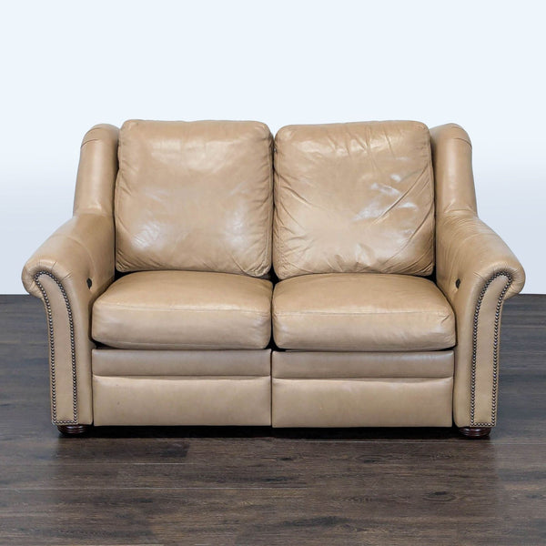 Bradington-Young loveseat in soft tan leather with nailhead trim and dual reclining seats.