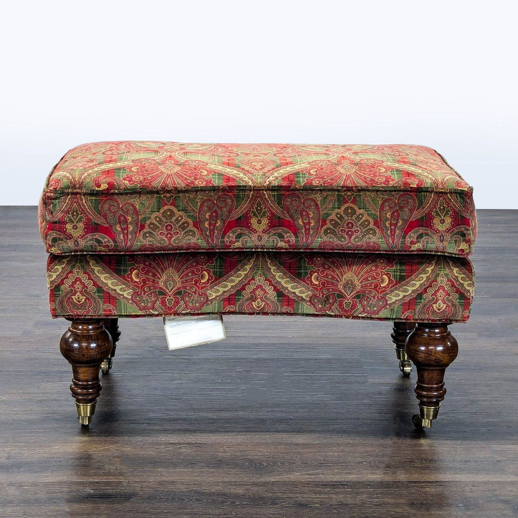 Ornate turned legs with casters on a furniture piece by Lillian August.  