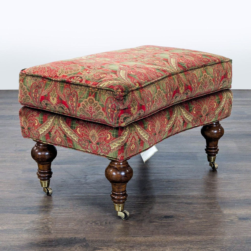 Close-up of Lillian August furniture showing elegant turned legs and rolling casters.  