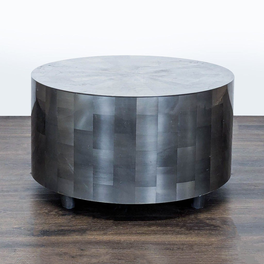 Modern round coffee table featuring hand cut clear and silver resin veneer; Oly Studio design.