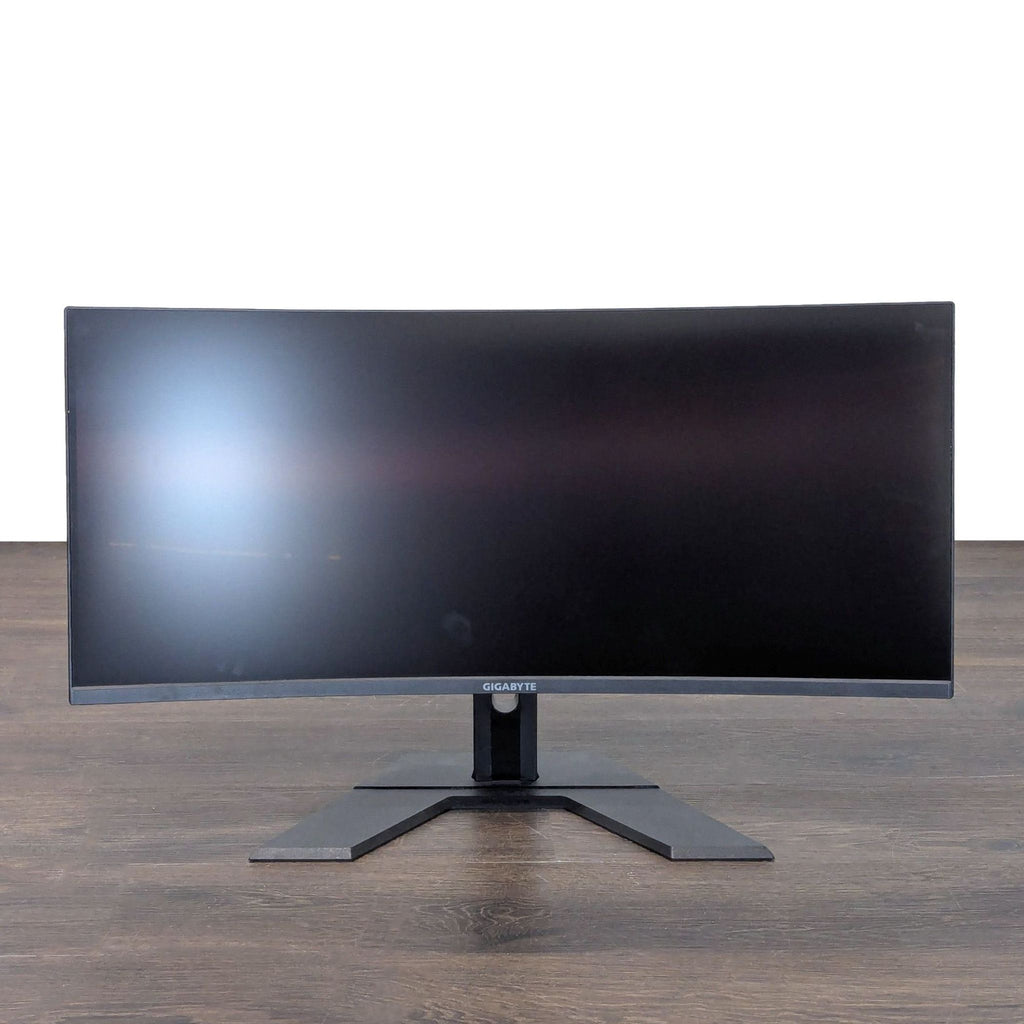 Gigabyte 34-inch curved ultra-wide monitor with sturdy stand, ideal for multitasking or gaming setups.