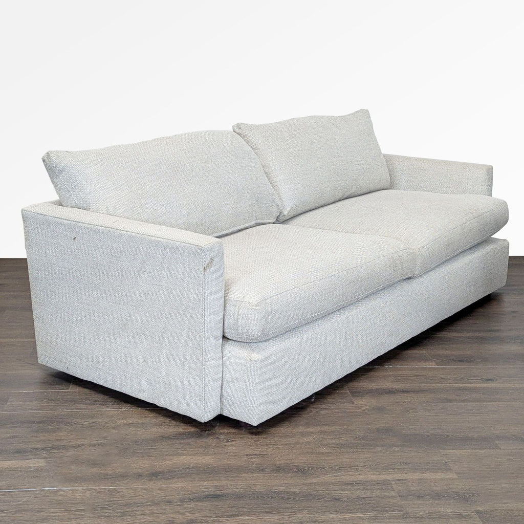 Modern Crate & Barrel three-seater sofa in soft neutral fabric, featuring a sturdy build and comfy cushions.