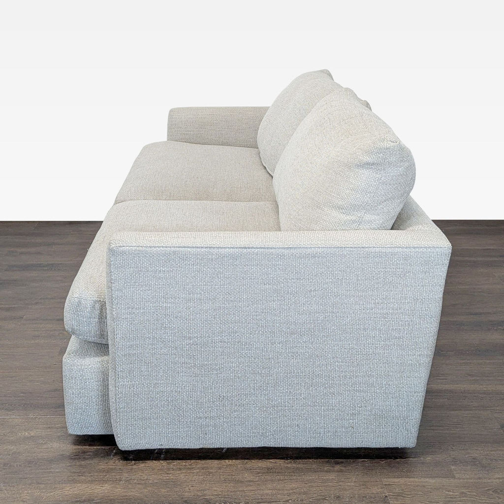 Neutral fabric Crate & Barrel sofa, three seats, straight-arm style, some arm wear, ideal for cozy living spaces.