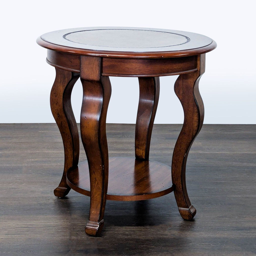 Traditional end table with elegant cabriole legs and a polished wood finish.  
