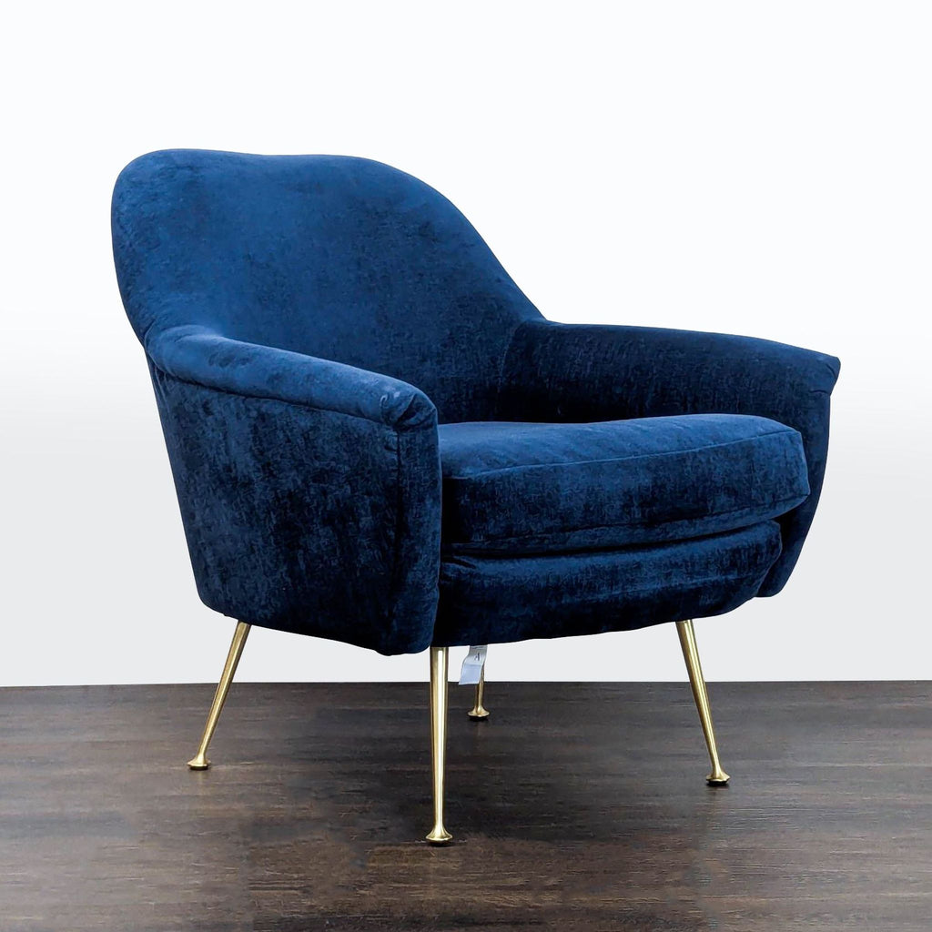 Modern West Elm lounge chair featuring plush blue upholstery and sturdy gold legs for stylish comfort.  