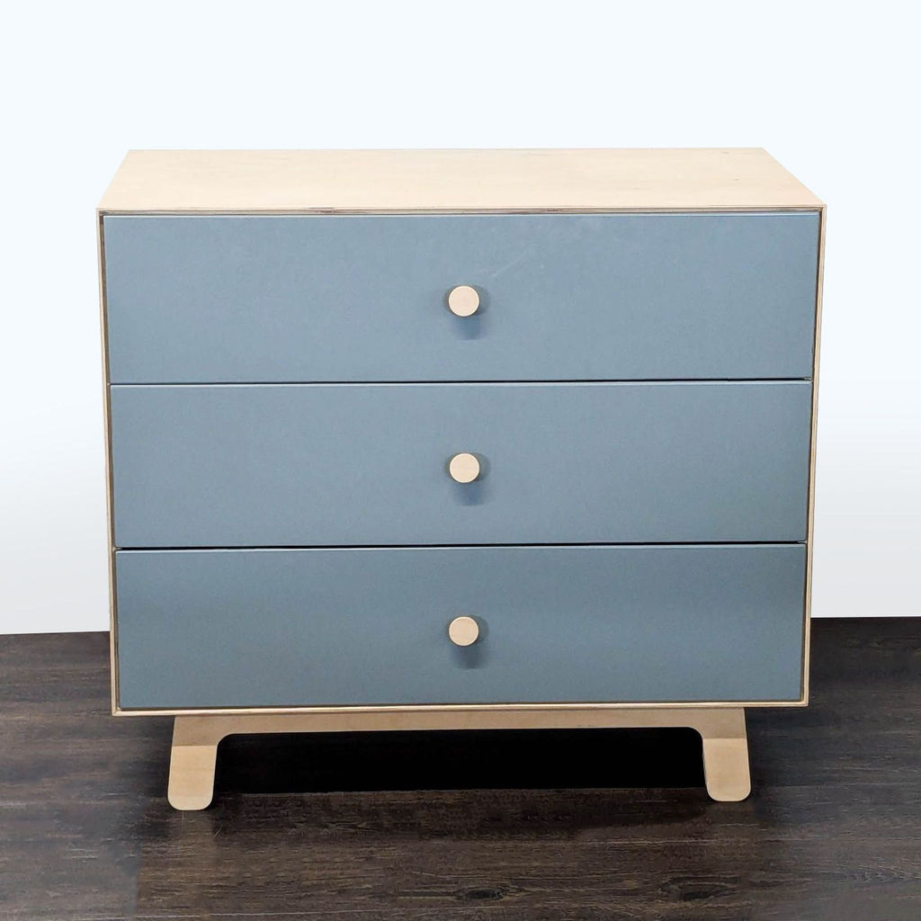 Modern Ouef dresser with blue drawer fronts, natural wood sides, and three round-handled drawers.  