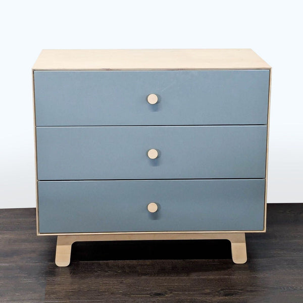 Modern Ouef dresser with blue drawer fronts, natural wood sides, and three round-handled drawers.  