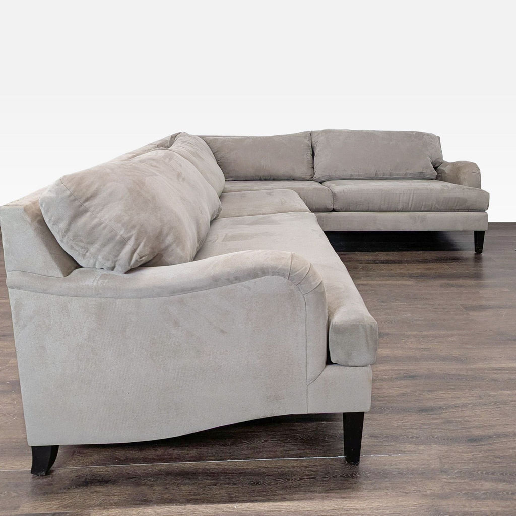 Modern sectional sofa with clean lines, soft fabric upholstery, and spacious seating in a neutral color.