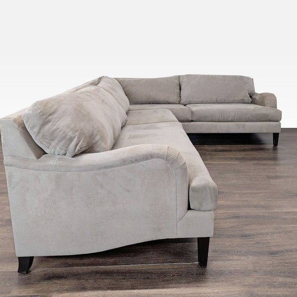 Modern sectional sofa with clean lines, soft fabric upholstery, and spacious seating in a neutral color.