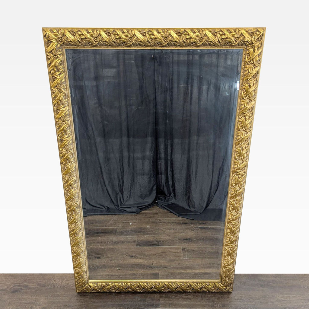 1. Rectangular mirror with ornate gold frame, standing against a dark curtain and wood floor background.