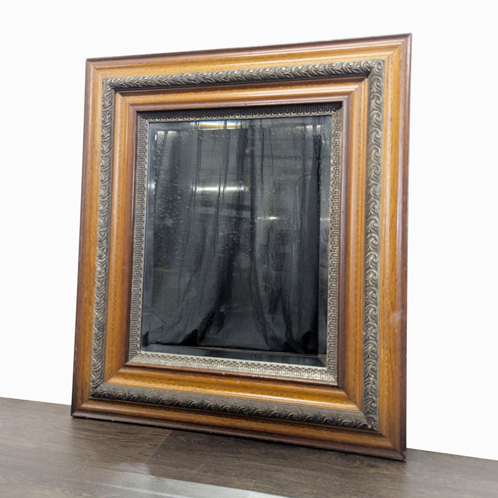 2. Decorative framed mirror with carved pattern trim and brown wood, viewed from an angled side perspective.