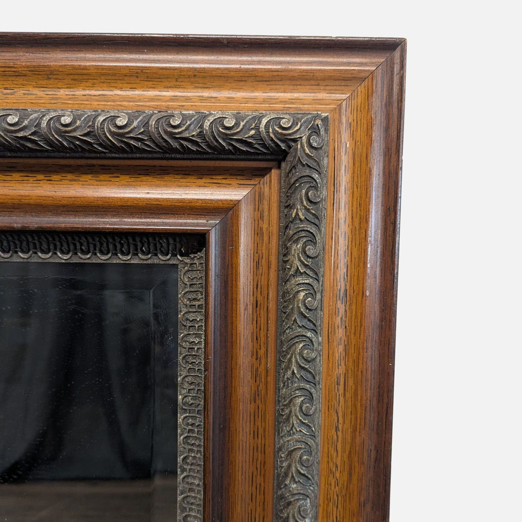 3. Close-up of framed mirror corner, highlighting intricate carved details and rich wood grain texture.