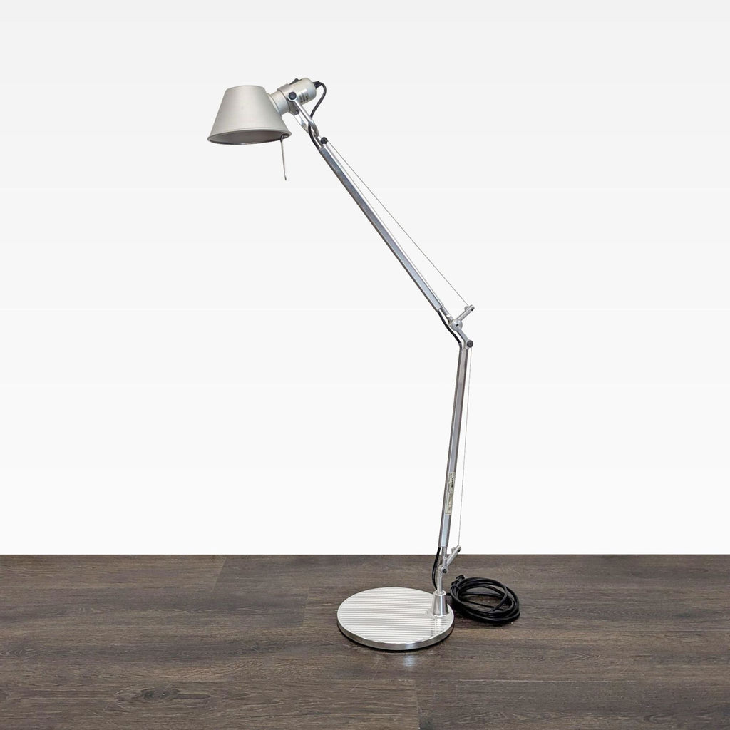 Artemide chrome floor lamp with adjustable arm and cone shade, ideal for focused lighting; Lighting category.  