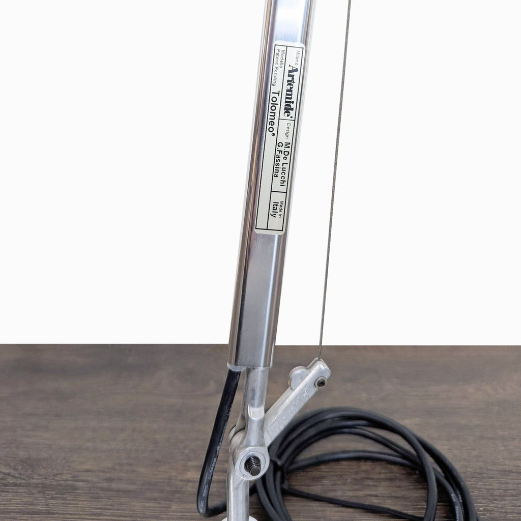 Sleek chrome Artemide lamp with classic cone-shaped shade for task lighting; Lighting category, adjustable arm.
