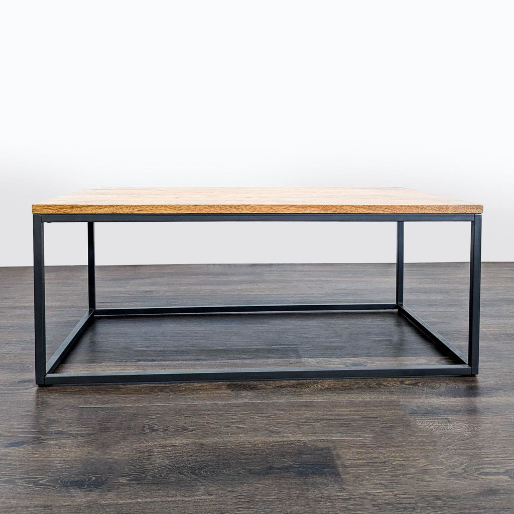1. Industrial coffee table by West Elm with wood top and blackened steel base, shown on a dark wood floor.  