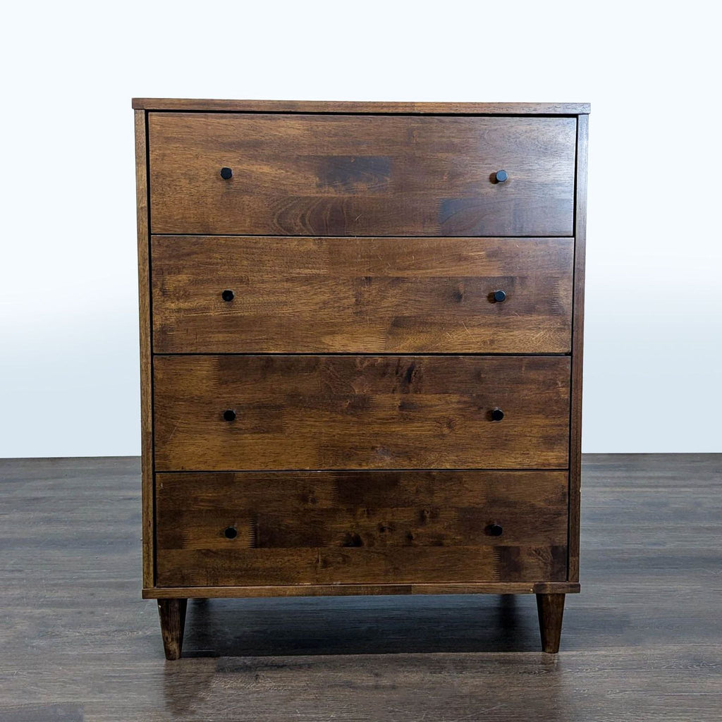 Dark brown wooden dresser with four roomy drawers and black knobs, perfect for modern bedroom storage.