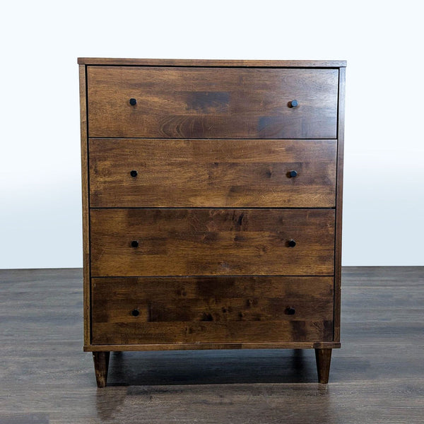 Dark brown wooden dresser with four roomy drawers and black knobs, perfect for modern bedroom storage.