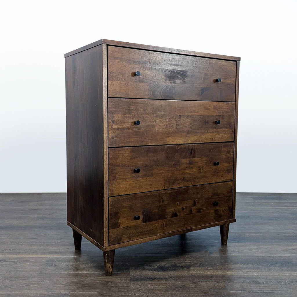 Sturdy, modern dresser with deep drawers and black knobs, ideal for organizing clothes in any room.