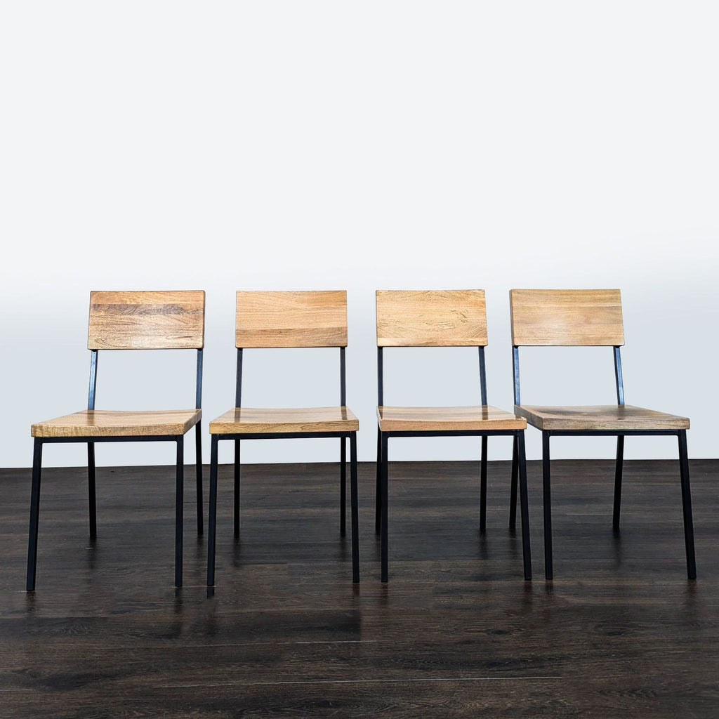 Modern West Elm dining set with space-saving drop-leaf table and four chairs, black metal accents.