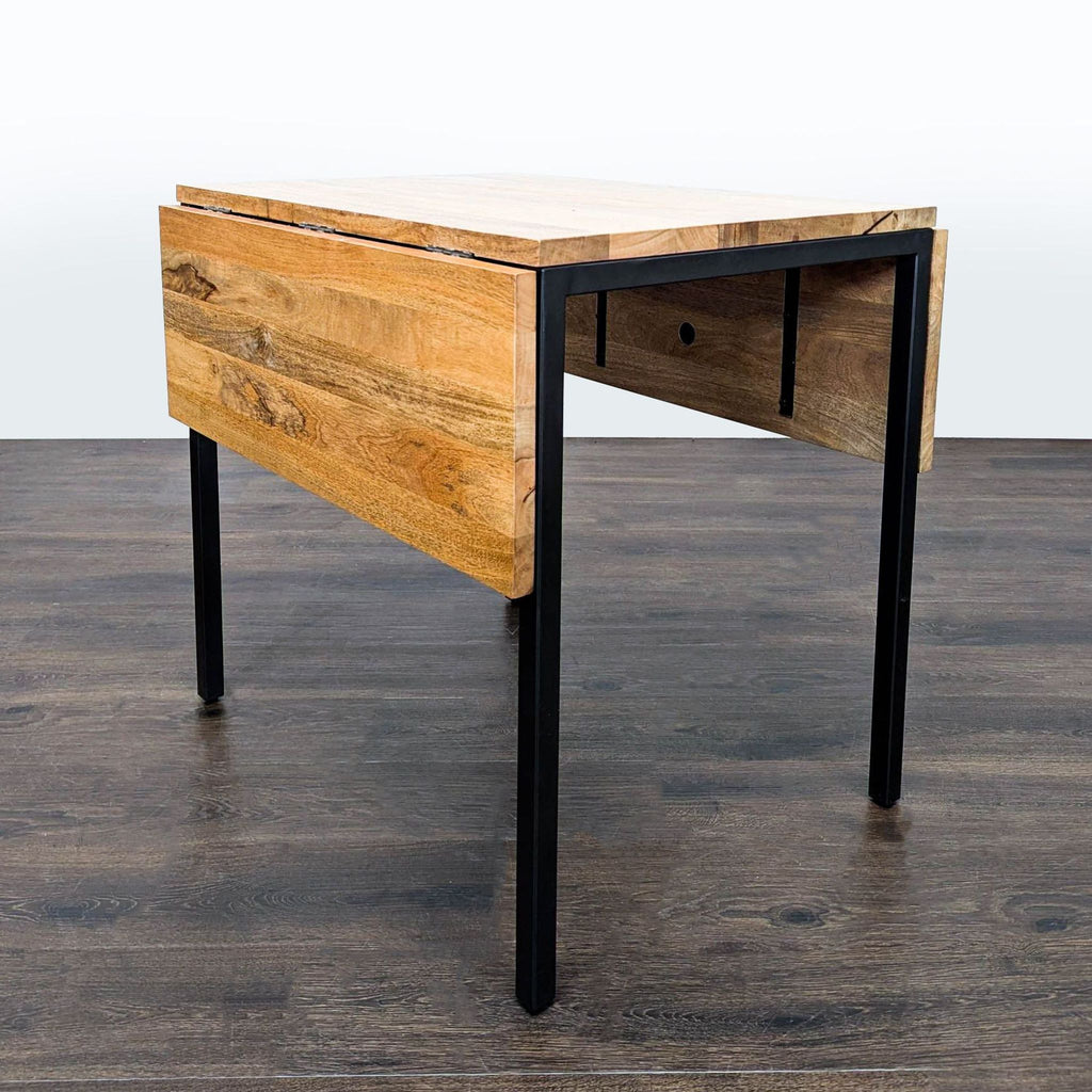 Compact West Elm dining set featuring expandable wood table and four chairs, ideal for small spaces.