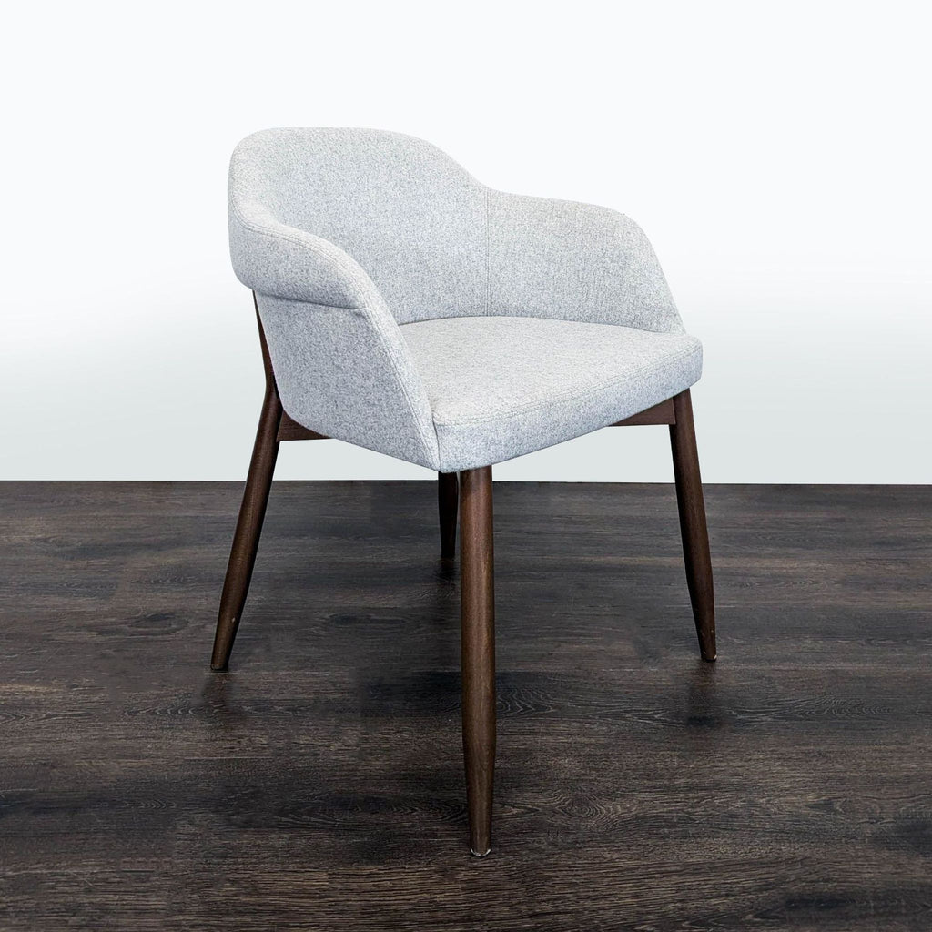 2. Contemporary dining chair by Billiani with rounded shoulder seat and angled wooden legs, upholstered finish.