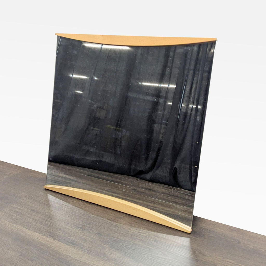 2. Angled view of a modern Calligaris mirror showing cherry wood frame, designed in Italy by Edi and Paolo Ciani.  
