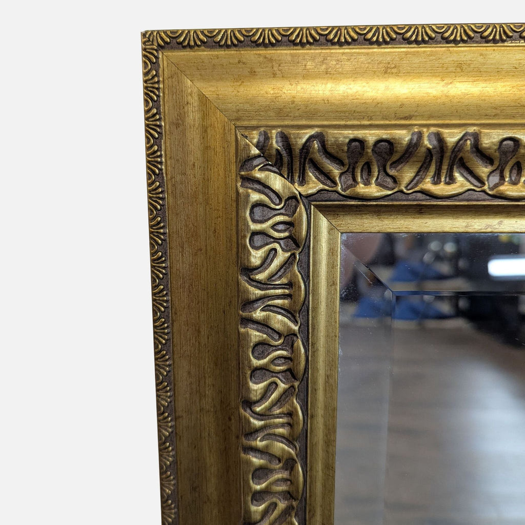 3. Close-up of the mirror’s gold frame, highlighting intricate carved decorative details and beaded edges.