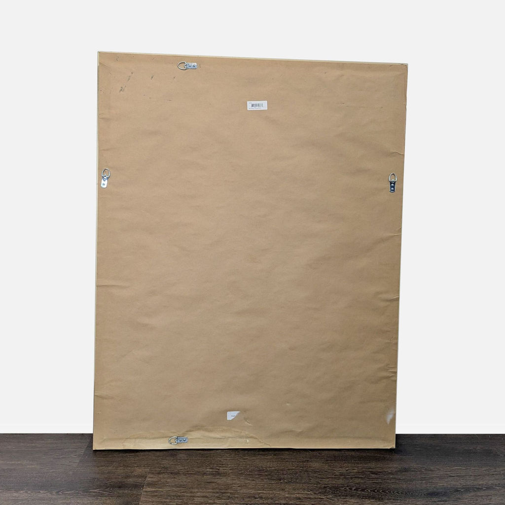 2. Back view of a large rectangular mirror with brown paper backing and metal hanging hardware.