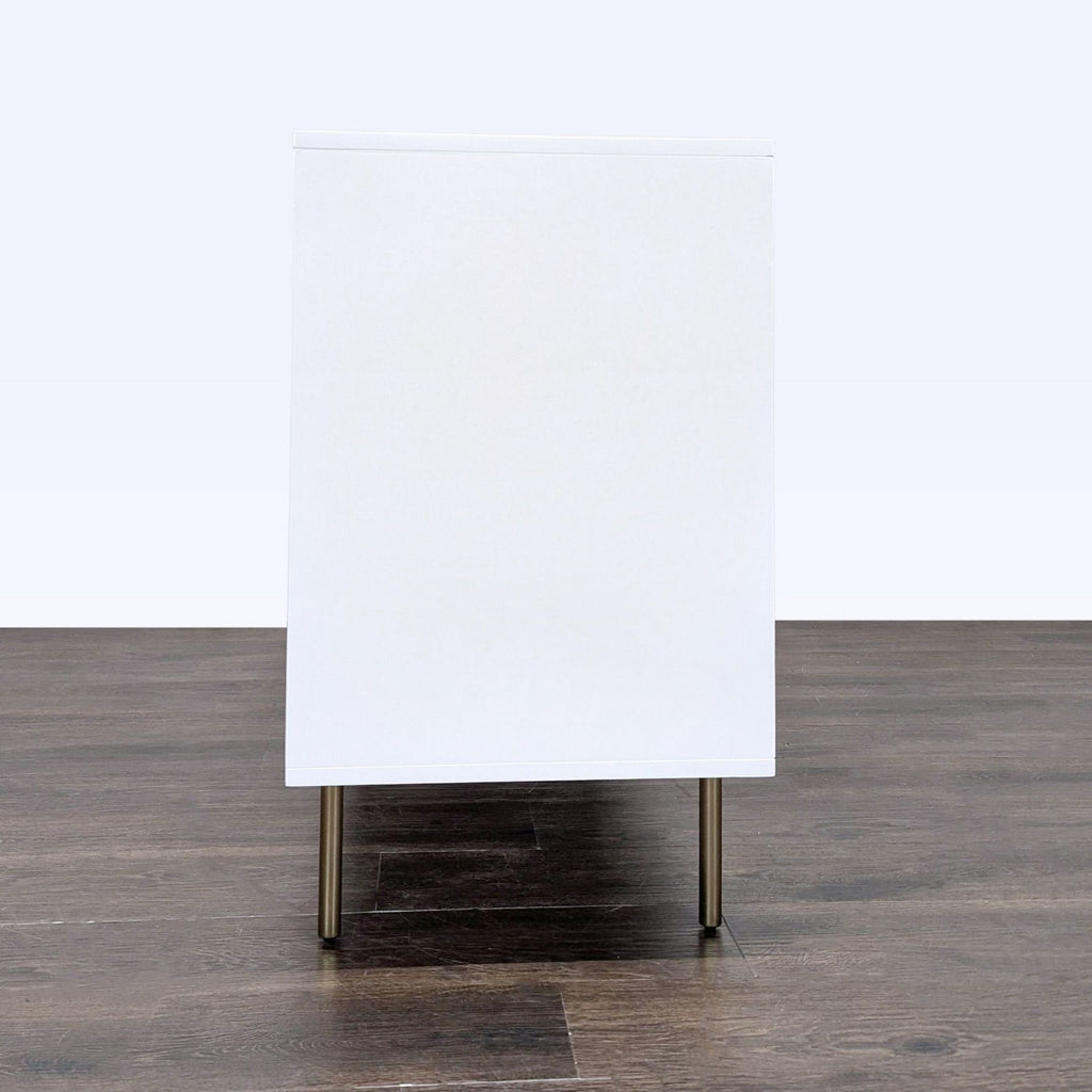 Pottery Barn geometric white dresser with six drawers, brass accents, and slight surface scratches visible.