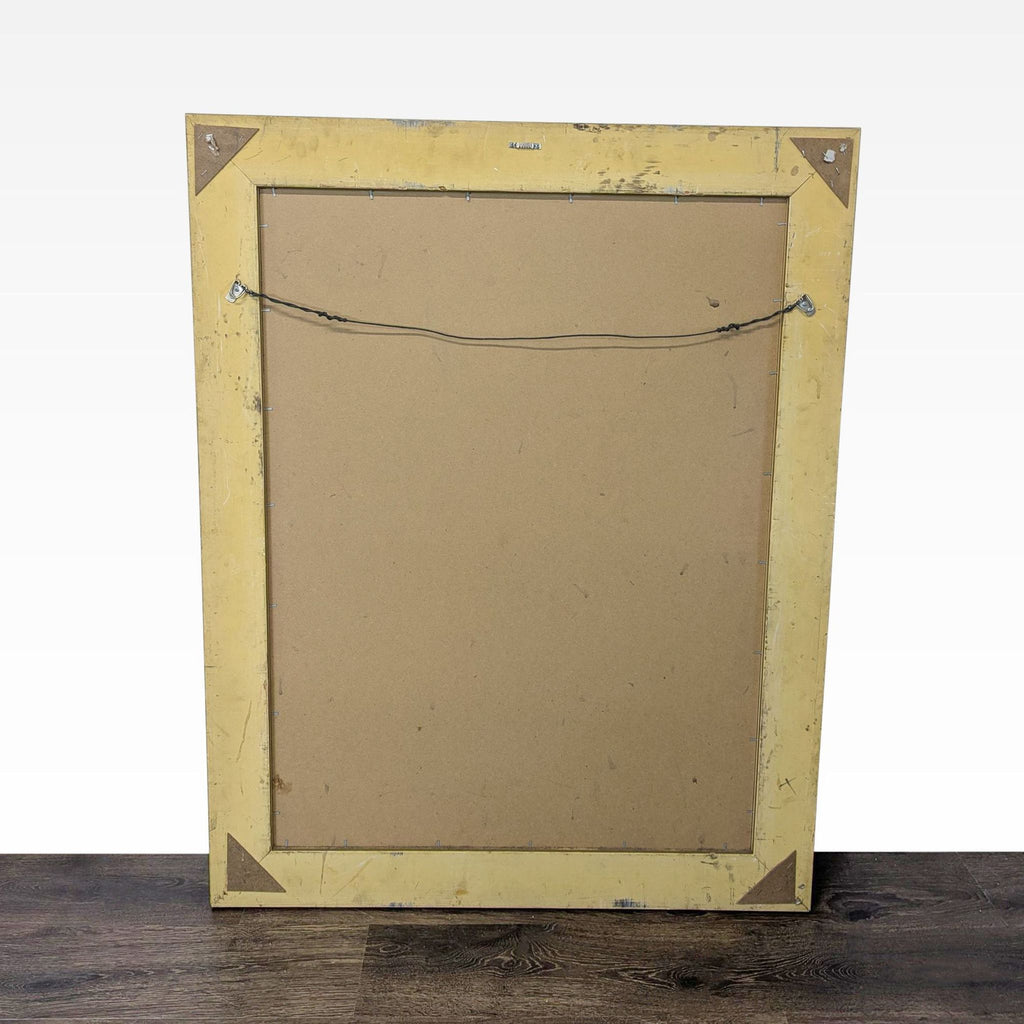 3. Back view of the framed Curt Walters coastal landscape artwork, showing hanging wire and simple backing.