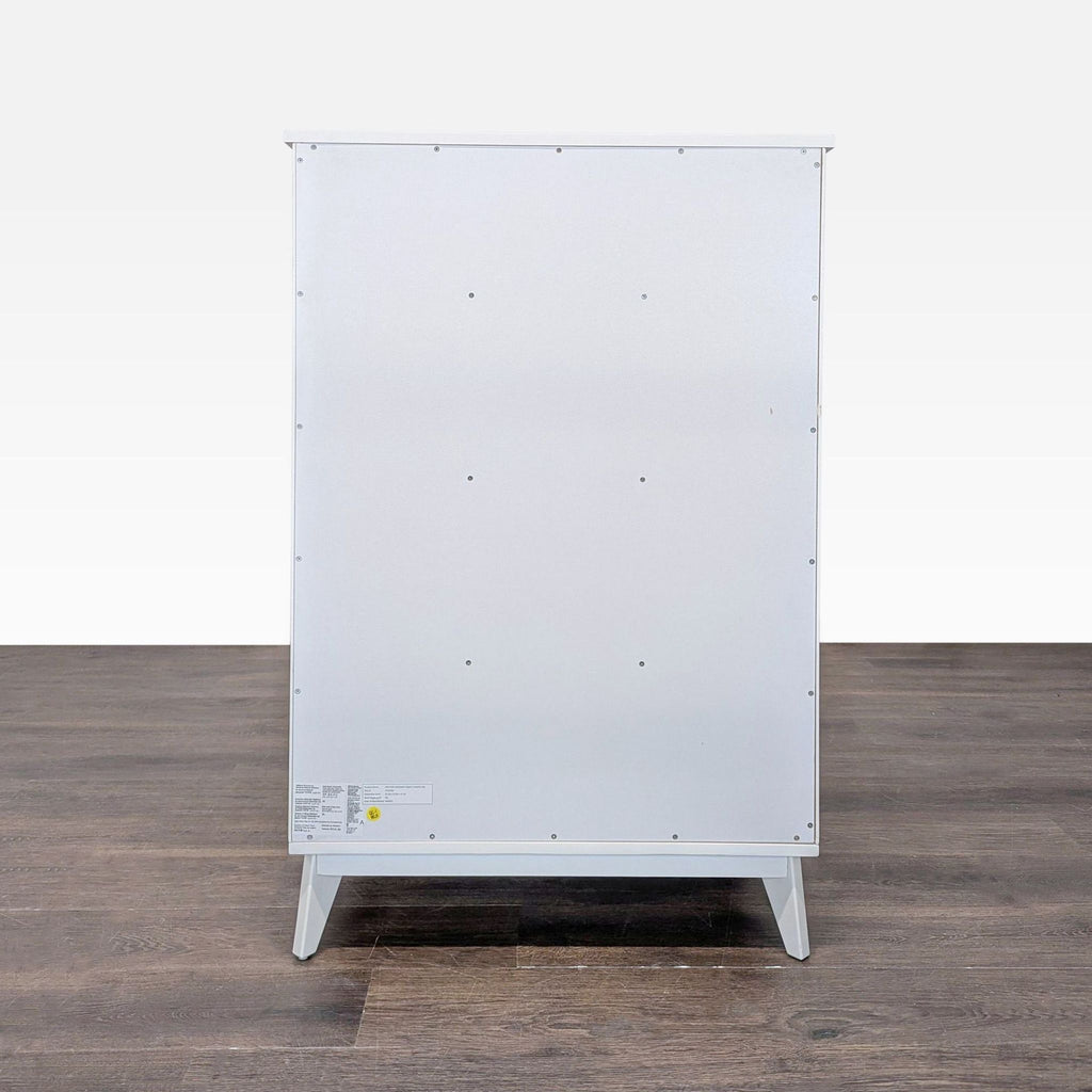 Back view of a Pottery Barn Teen dresser, showing a plain white panel and clean, minimal design.