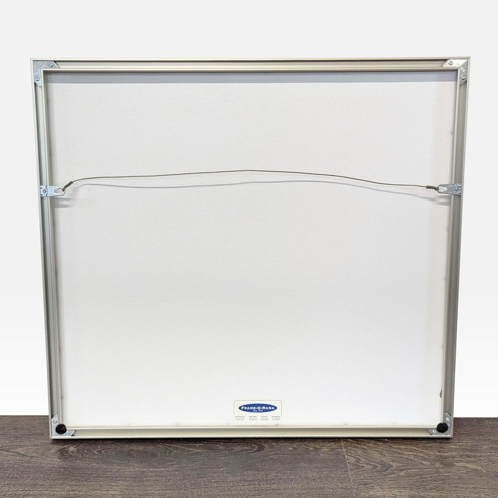 Back of the art print’s silver frame with hanging wire, showing it is ready for easy wall mounting.