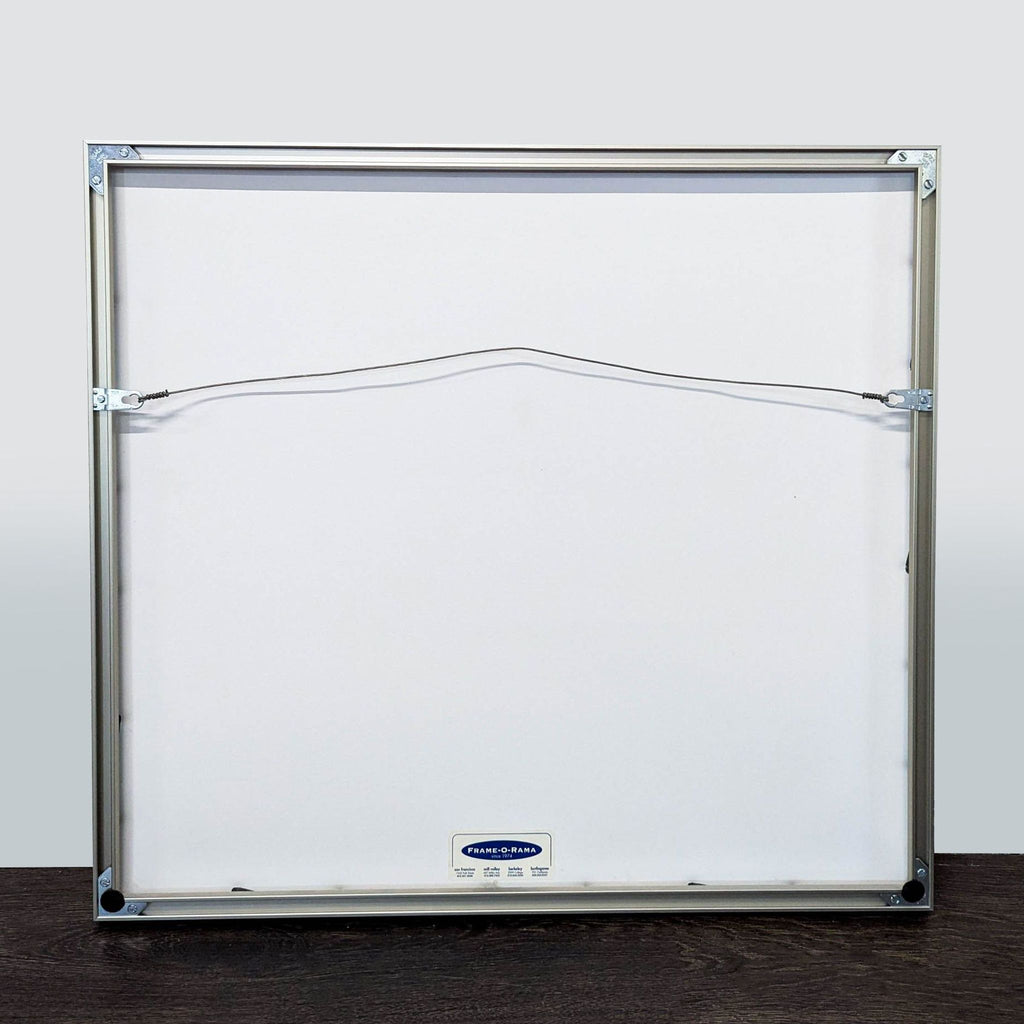 3. Back view of a professionally mounted print in a metal frame with hanging wire, ready to display.