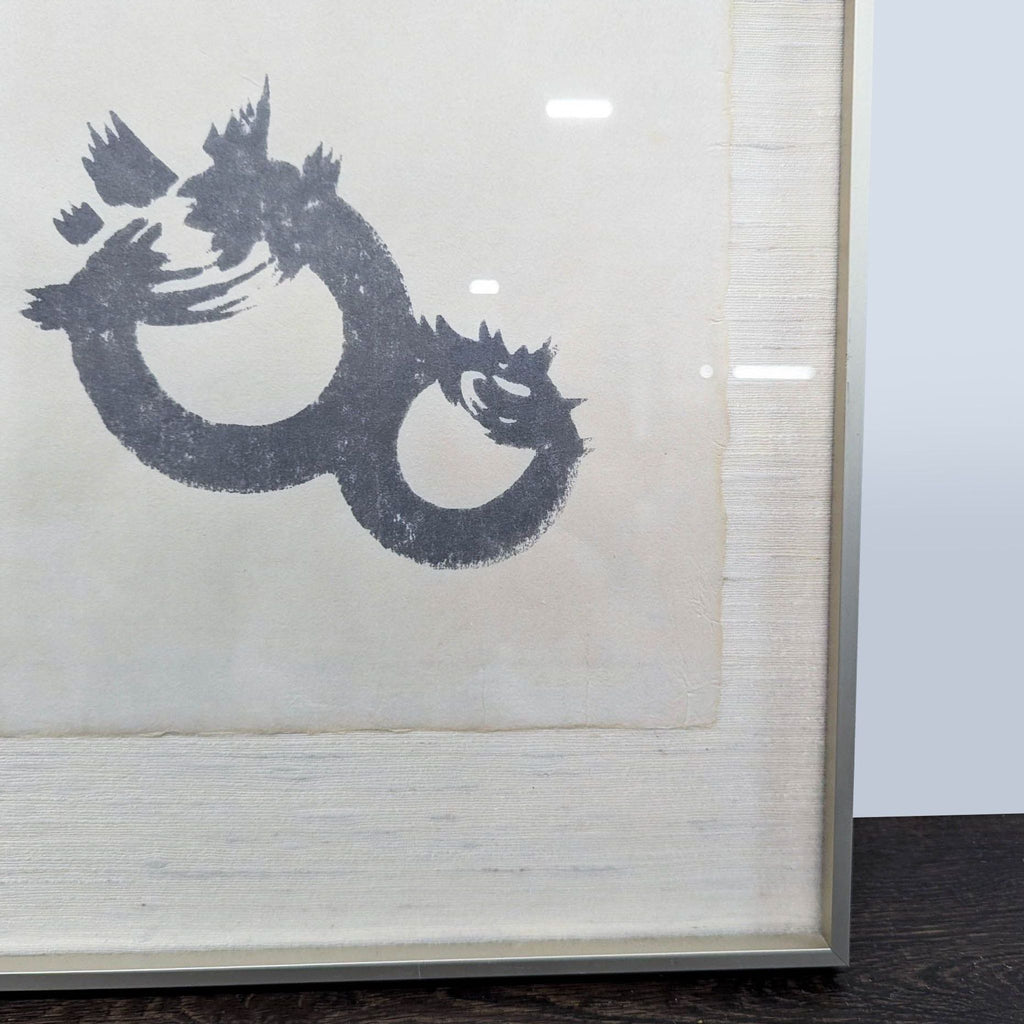 2. Close-up of bold circular ink brushwork on silk, highlighting the textured abstract design and framing.