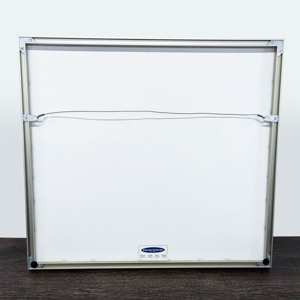 3. Back view of framed artwork in silver metal frame, showing hanging wire and label for Prints & Maps category.