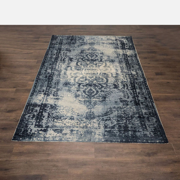 West Elm Arabesque 8x10 area rug with blue and ivory distressed trellis pattern, vintage-inspired style.