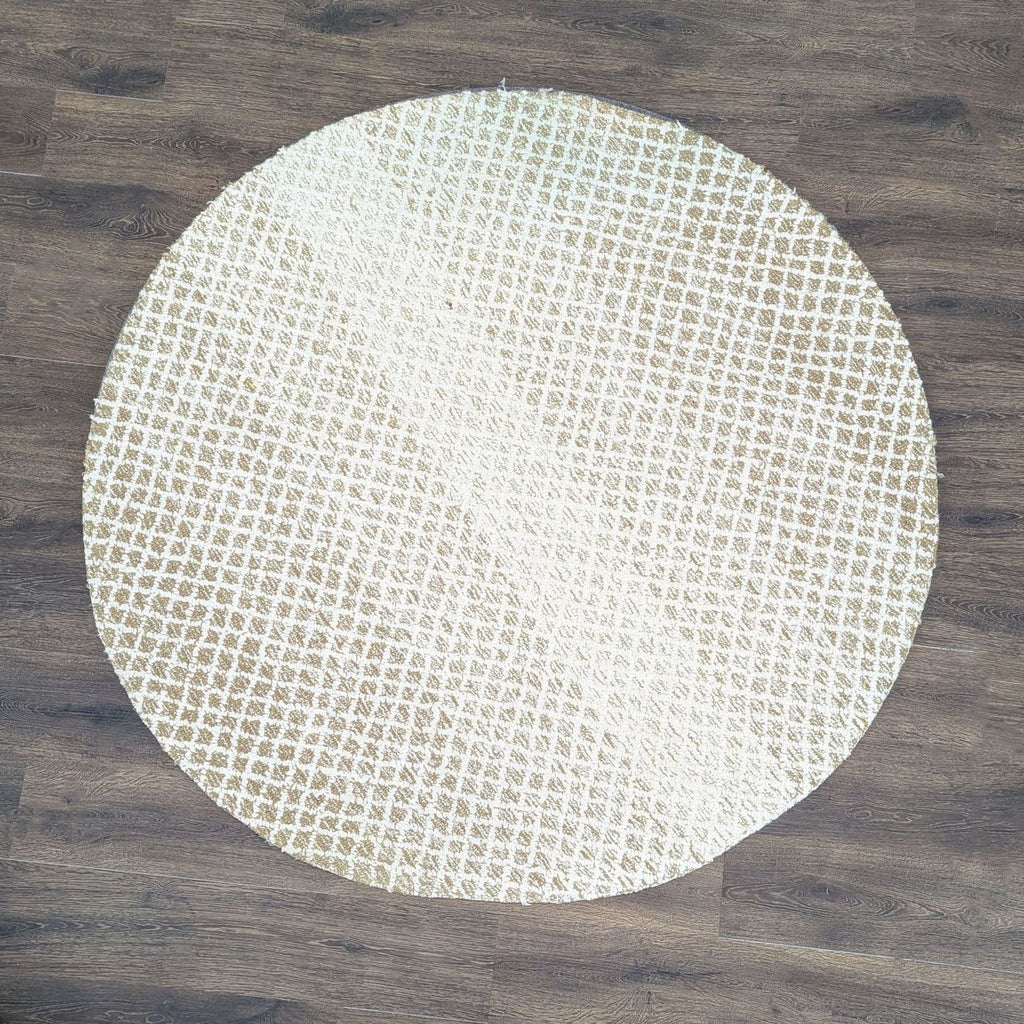 1. Safavieh round rug with beige and white geometric pattern on a textured weave, displayed on a wood floor.