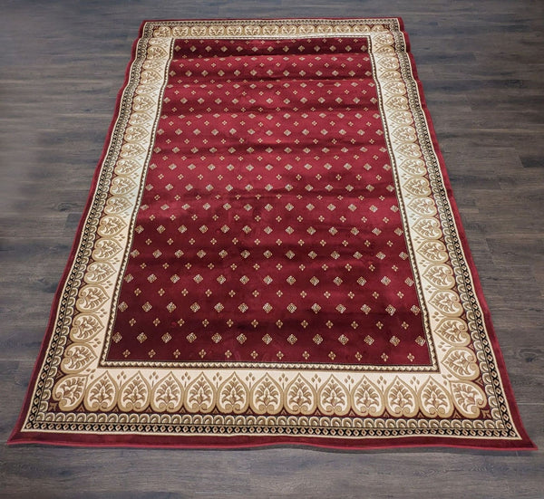 Red Fleur De Lis area rug from the Sapphire Collection, size 7'10" x 11'2", shown in a living room.