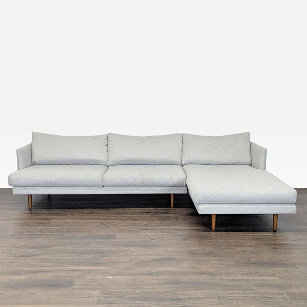 Modern Article sectional sofa in light grey fabric with chaise and wooden legs, ideal for contemporary living rooms.