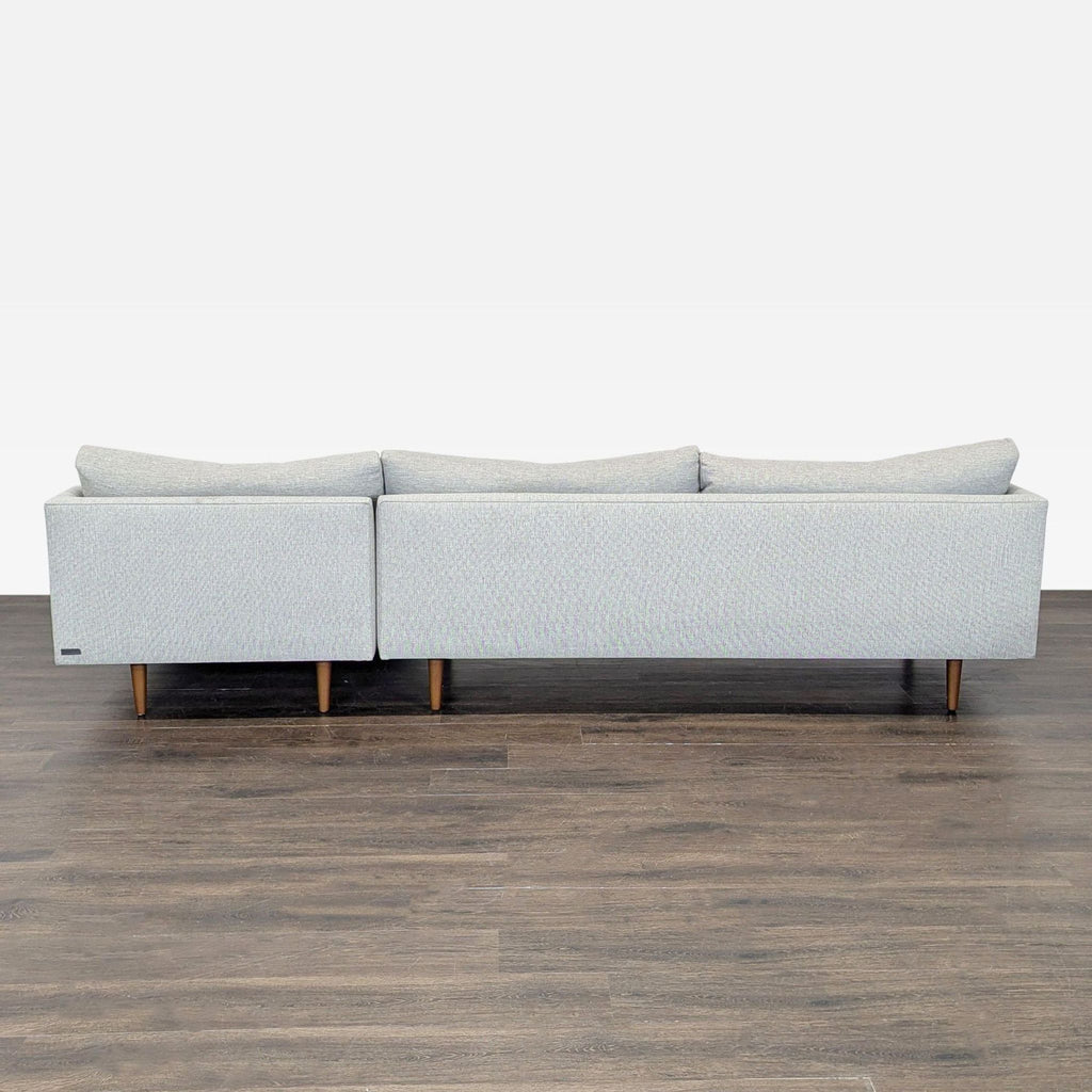 Article brand sectional sofa in soft grey, includes a roomy chaise and wooden legs; clean, stylish, and comfortable.
