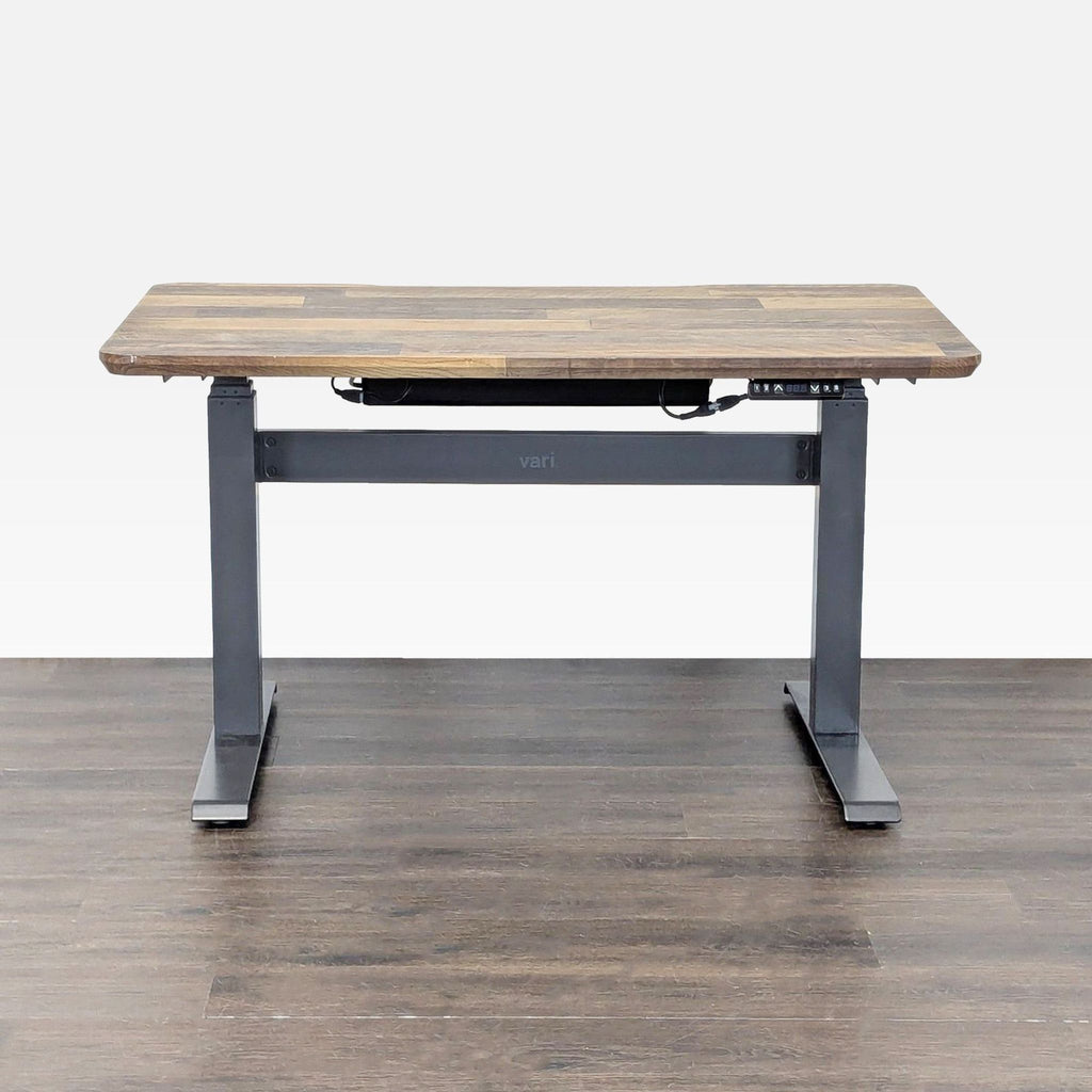 Varidesk standing desk with wood top and steel frame, featuring electric height adjustment for versatile use.  