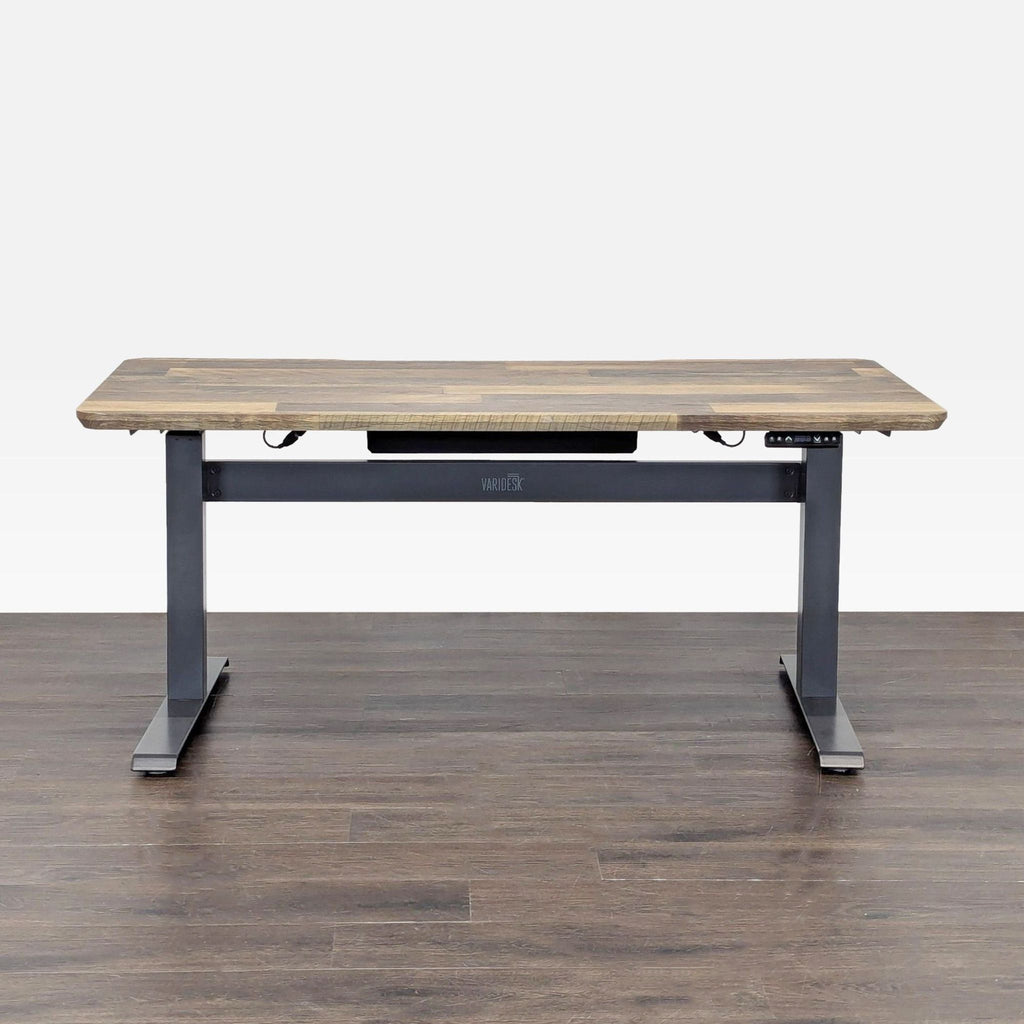 Varidesk electric desk with wood top and metal frame, adjustable height for sitting or standing work positions.  