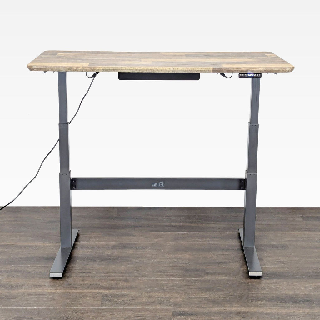Modern Varidesk adjustable desk, sturdy metal base, wood finish surface, easy button for height switching.  