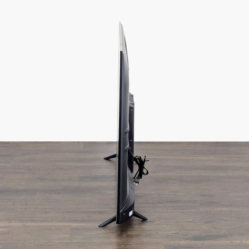 Close-up of the Hisense Roku TV screen and stand, highlighting easy navigation and TV's well-kept appearance.