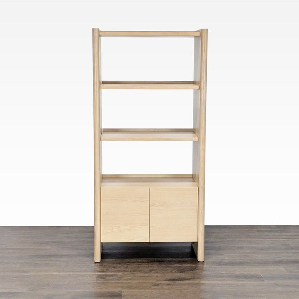 Light wood bookshelf by Article with three open shelves and a two-door cabinet in a modern design.