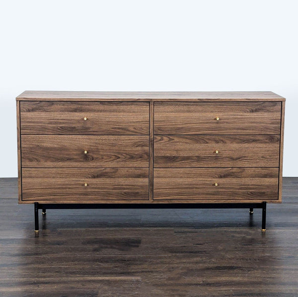 Ikea walnut dresser with six spacious drawers, black metal legs, and gold accents; modern and sleek.