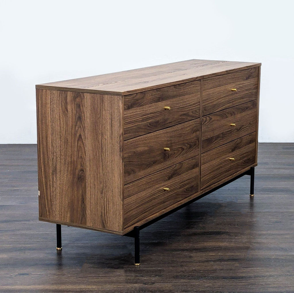 Modern Ikea dresser in walnut finish, featuring gold-accented black legs and ample storage with six drawers.