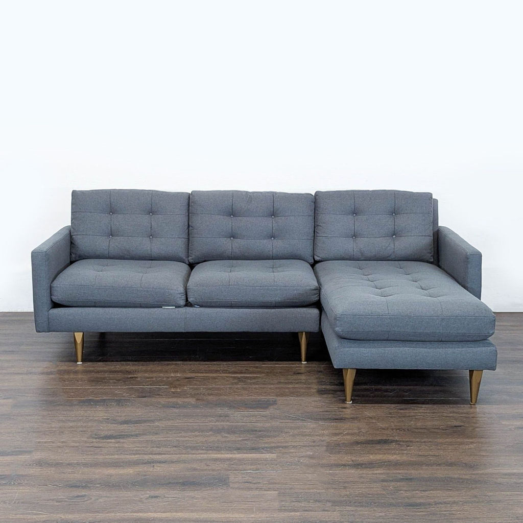 Crate & Barrel gray sectional with a right-facing chaise, tufted cushions, and tapered legs in a modern style.  
